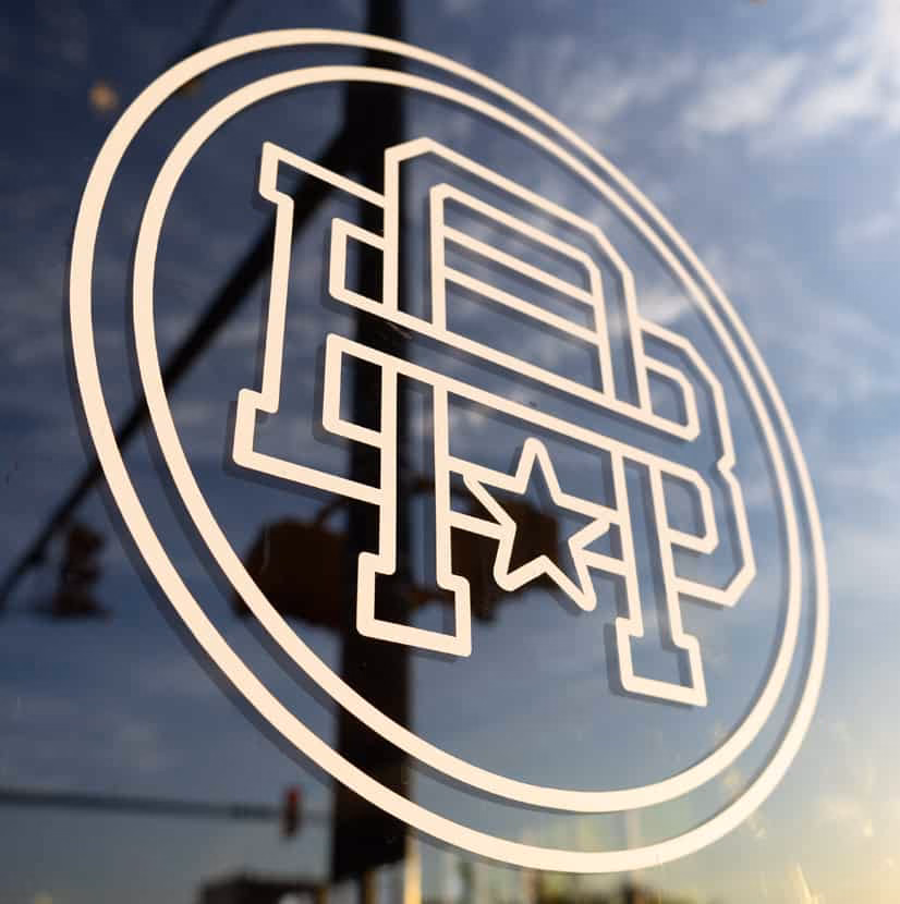 Americana Beer Company window logo graphic at sunset - Monroe, NC